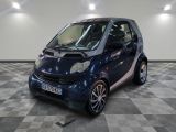 the smart car is parked on a checkered floor in the garage