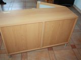 a wooden cabinet with a glass door in the middle of the room