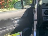 a car door open with the driver ' s seat down