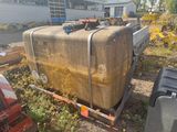 a large piece of luggage sitting on a trailer in the grass