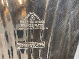 a silver plate with a picture of a man and a woman on it