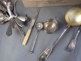a lot of silverware on a table with a box