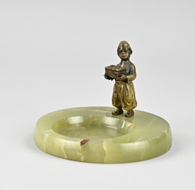 an antique bronze figurine of a boy holding a book
