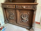 a wooden cabinet with carvings on it in a room