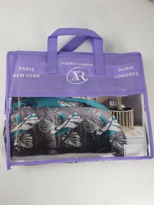 purple shopping bag with a tropical print on it sitting on a white table