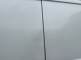 a white van that is parked on the side of the road
