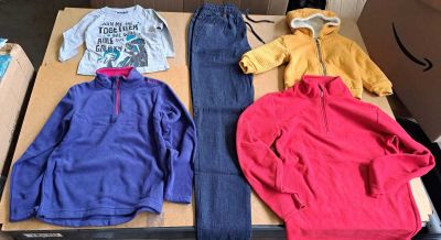 three pairs of clothes laid out on a table