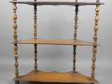 a wooden shelf with three shelves on top of it