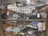 a metal cart with many items in it in a warehouse