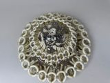 a picture of a brooch made out of white beads
