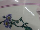 a close up of a plate with a flower design on it