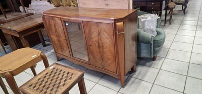 a wooden cabinet with a glass door in the middle of a room