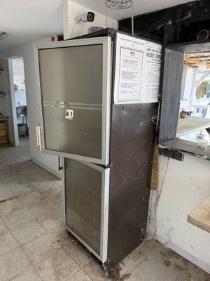 a refrigerator in the middle of a kitchen that is being remodeled