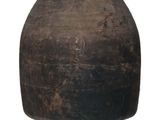 a large brown pot sitting on a white surface