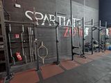 a view of a crossfit gym with a wall mounted rack