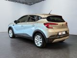 the rear end of a silver car in a white room