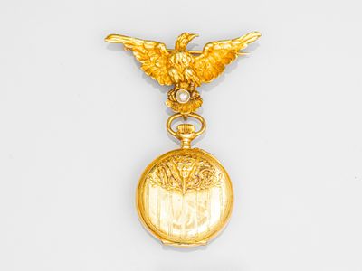 une image représentant une montre de poche plaquée or sur laquelle figure un oiseau