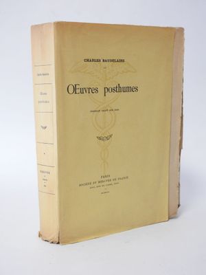 an old book sitting on top of a table next to a white wall