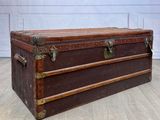 a brown trunk sitting on the floor in a room