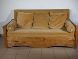 a couch that has some pillows on it in a room