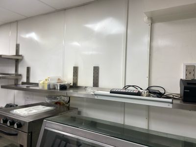 an image of a kitchen with a stove and microwave in it