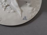 a white plate with a bird and flowers on it