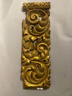 an ornate gold piece of art on display in a museum