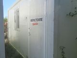 a small white building with a sign on it