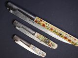 trois couteaux sont assis l'un à côté de l'autre sur une table