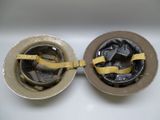 two metal bowls that have a yellow ribbon on them