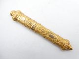an old gold pen with a white stone in the center