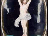 painting of a man on a cross on a plaque in a wooden frame