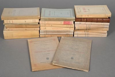 several old books stacked on top of each other on a table