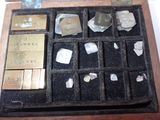 a wooden box filled with different types of metal