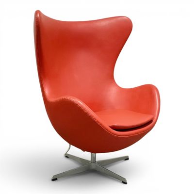 an image of a red chair with a metal base on a white background
