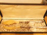 a silverware set in a black case on a table