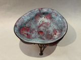 a bowl that is sitting on a stand on a table