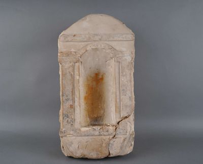 a stone block with a window in it on a gray surface