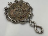 a close up of a coin on a chain on a white surface