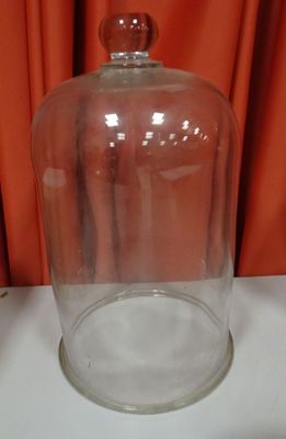 a large glass jar with a glass lid on a table