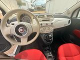 dashboard of a small car with red seats and a steering wheel