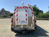 a white truck with a red and white stripe on the back of it