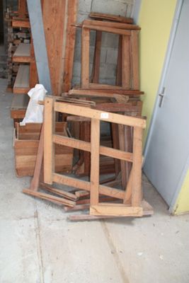 many pieces of wood stacked on top of each other in a garage