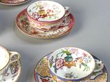 five cups and saucers with different designs on them
