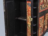 a black cabinet with a red and gold design on it