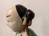 a figurine of a woman holding a child on her back