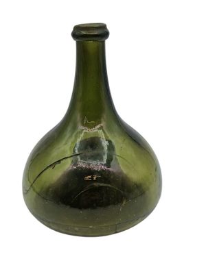 a green glass bottle with a hole in it