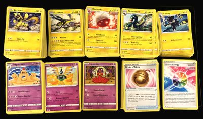 several pokemon cards are lined up on a black surface