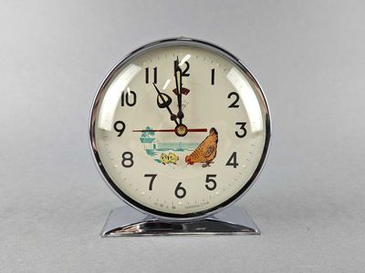 a clock with a picture of a fish and a bird on it