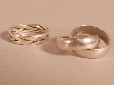 pair of silver rings sitting on top of each other on a table